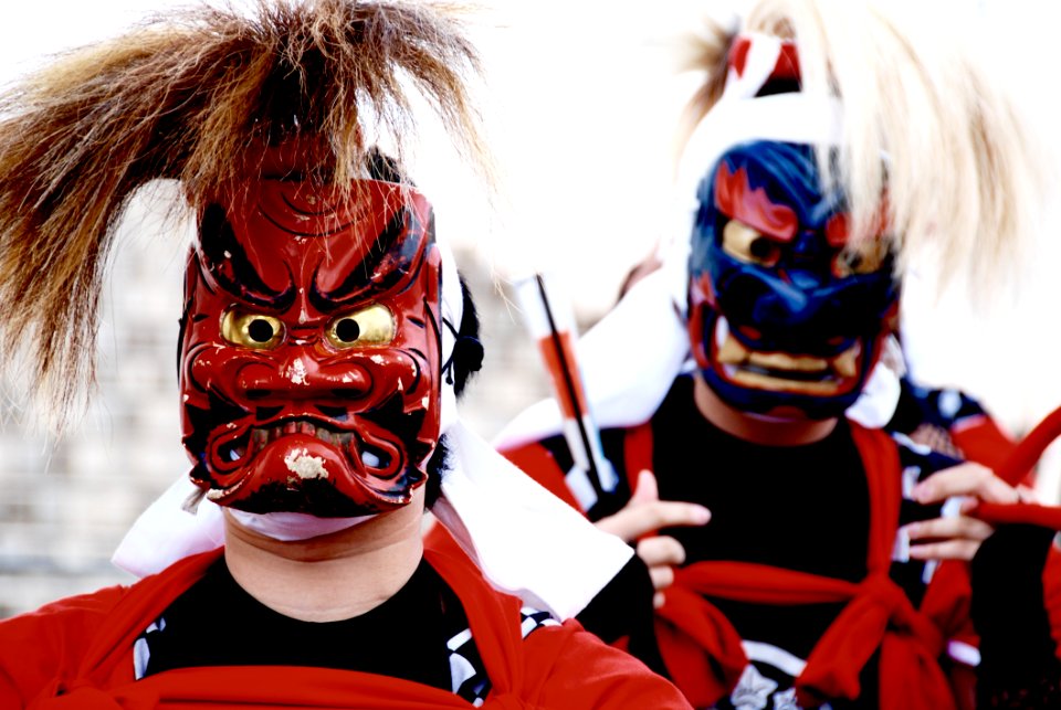 Persons Wearing Red And Blue Kabuki Masks