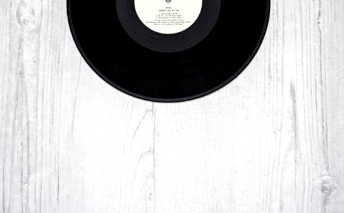 Black Vinyl Record On Wooden Surface photo