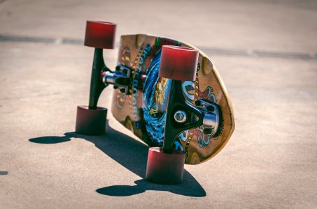 Shallow Focus Photography Of Brown And Blue Skateboard photo