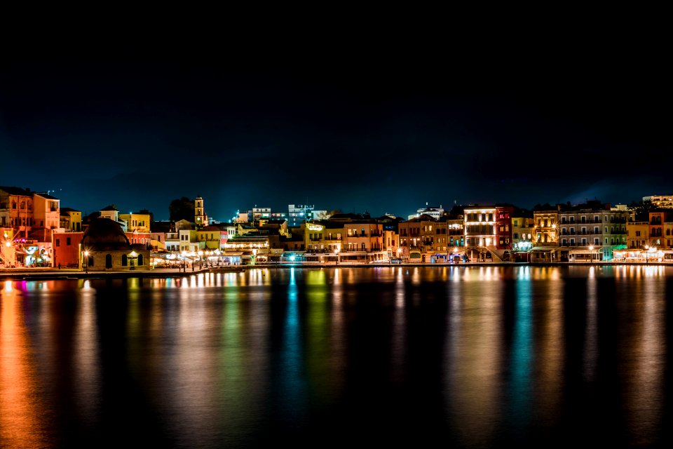 Cityscape Near Body Of Water During Nighttime photo