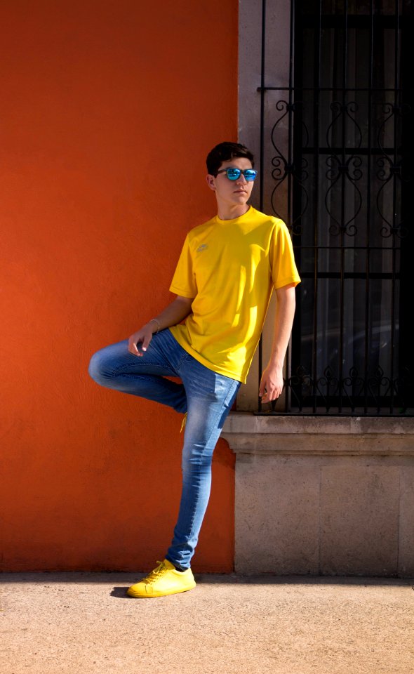 Man Wearing Yellow Crew-neck T-shirt And Blue Denim Jeans photo