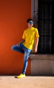Man Wearing Yellow Crew-neck T-shirt And Blue Denim Jeans photo