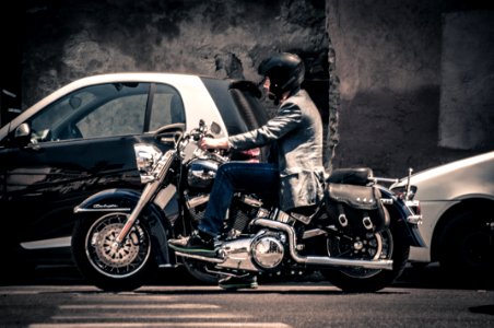 Man Riding A Black Touring Motorcycle photo