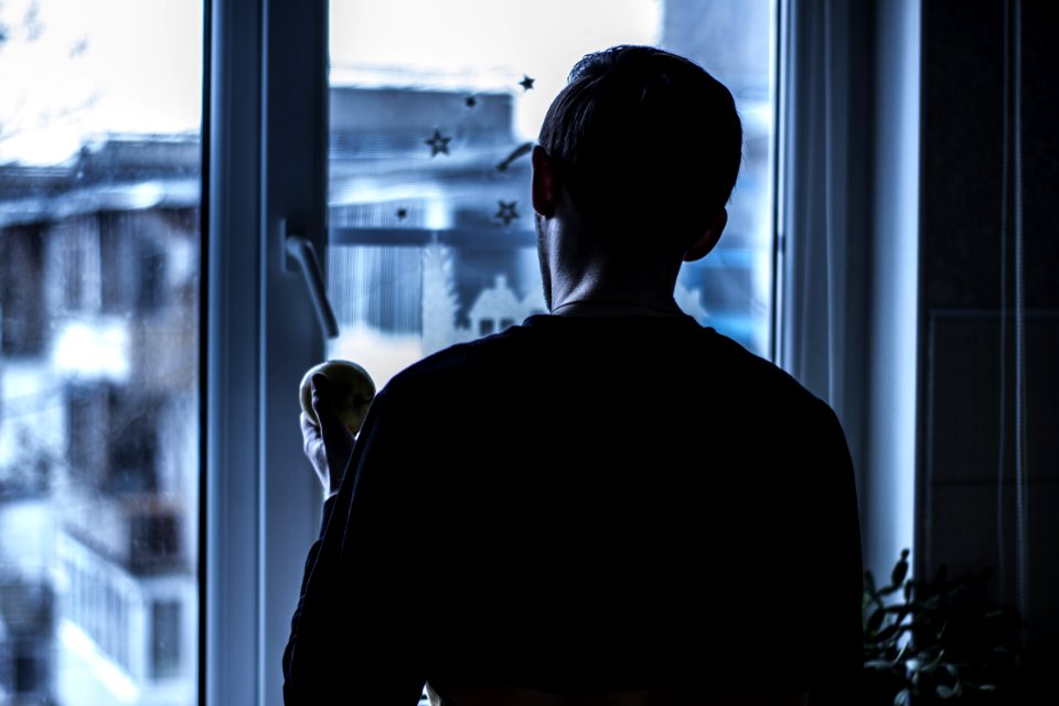 Man Looking Outside Near Clear Glass Window
