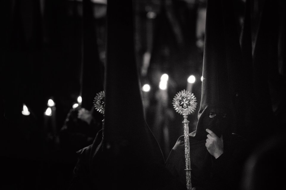 Grayscale Photo Of Person Wearing Balaclava Holding Wand