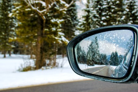 Framed Side Mirror Beside Snow Covered Field photo