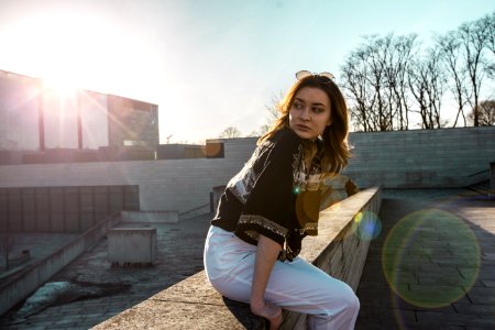 Woman In Black Top And White Pants