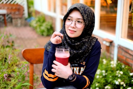 Woman Holding Cup Of Red Juice photo