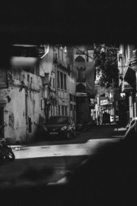 Grayscale Photography Of Car And Motorcycle Beside Building photo