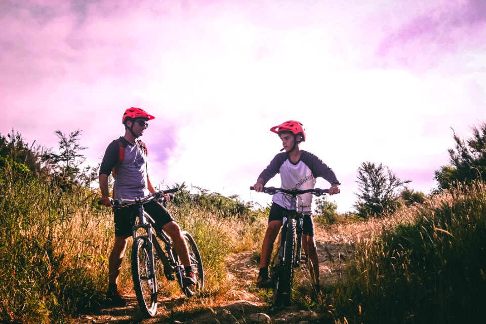 Two Man Riding Mountain Bike On Dirt Road At Daytime