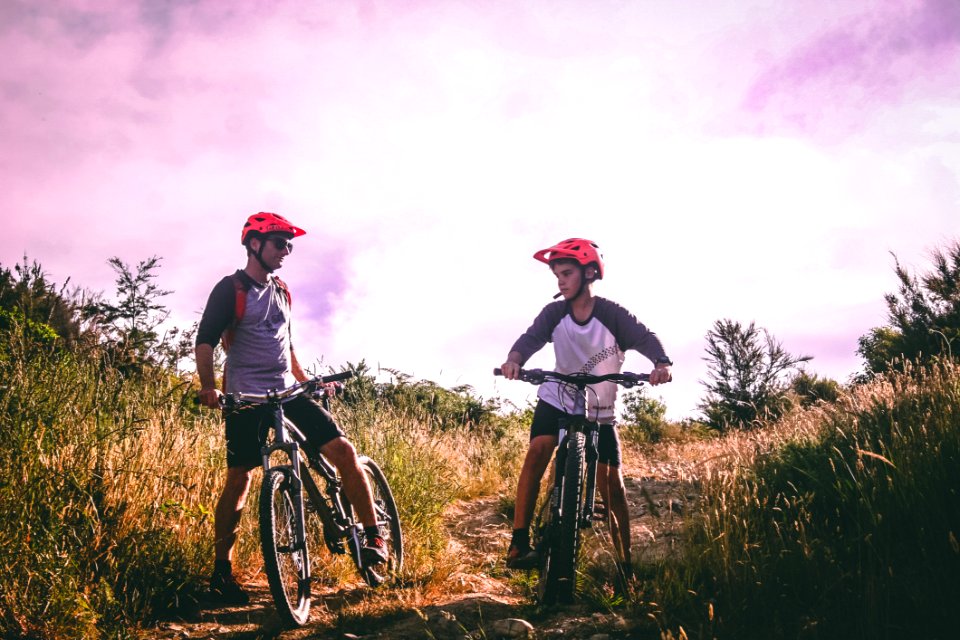 Two Man Riding Mountain Bike On Dirt Road At Daytime photo