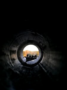 People Riding Canoe Boat View From Inside Pipe