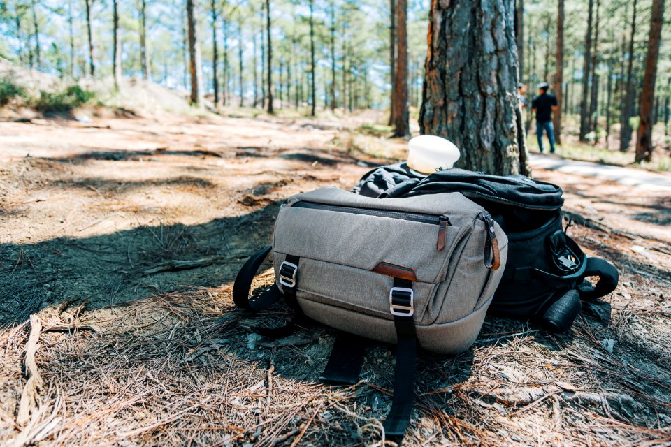 Photograph Of Two Duffel Bags Under The Tree In Forest