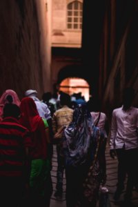 Photo Of People Walking Towards Gate photo