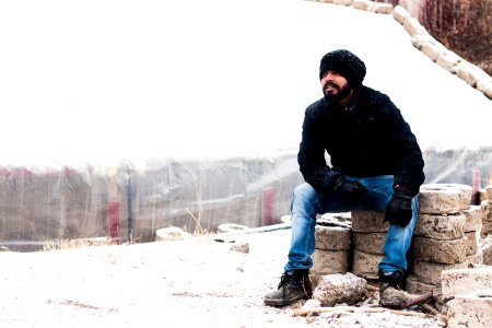 Man Wearing Black Coat And Blue Jeans photo