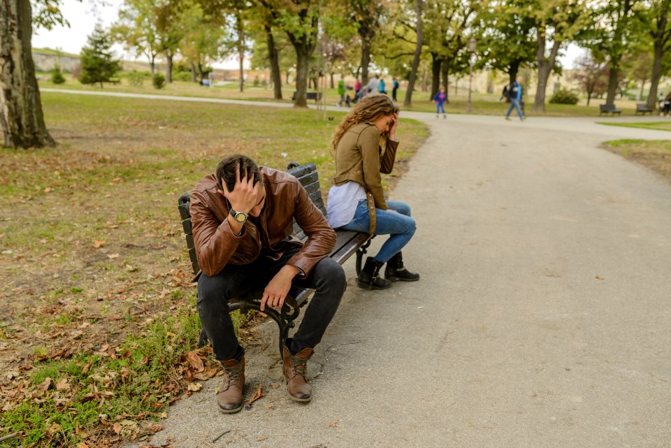 Man And Woman Sitting On Bench