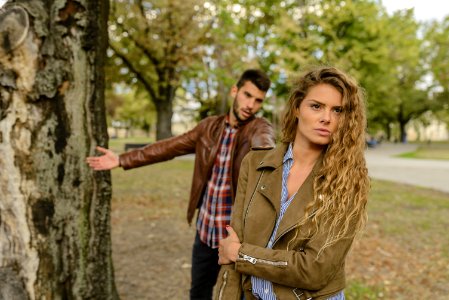 Woman And Man Wearing Brown Jackets Standing Near Tree photo
