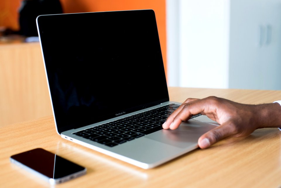 Persons Hand On Macbook Pro