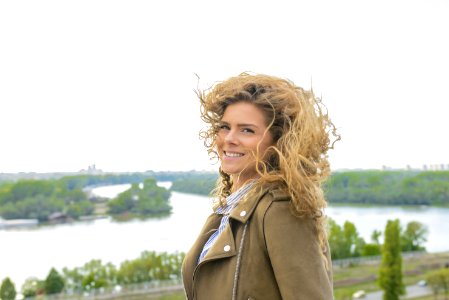 Woman Wearing Brown Coat Smiling photo