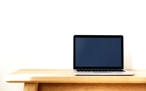 Black And Silver Laptop Computer On Brown Wooden Desk photo