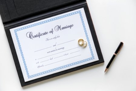Certificate Of Marriage And Two Gold-colored Rings photo