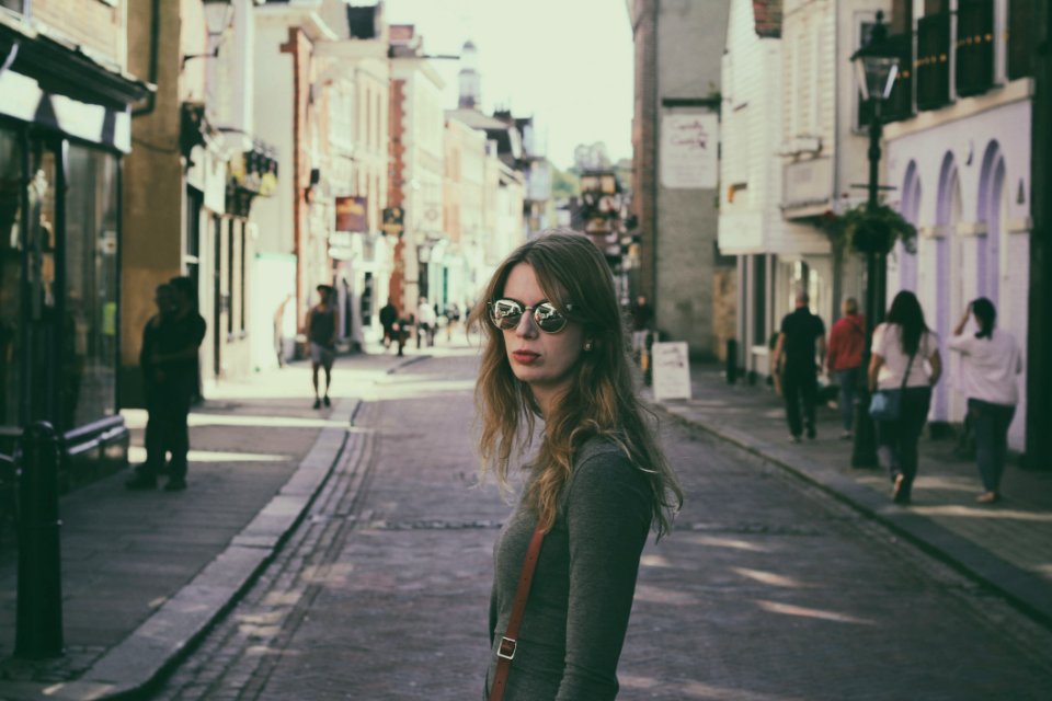 Woman Wearing Gray Long-sleeved Shirt Standing In The Middle Of Pavement