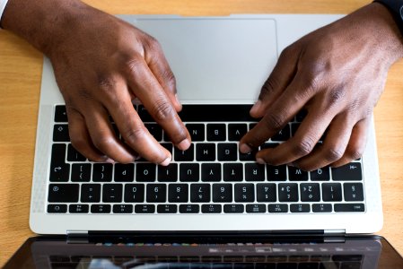 Person Typing On Laptop