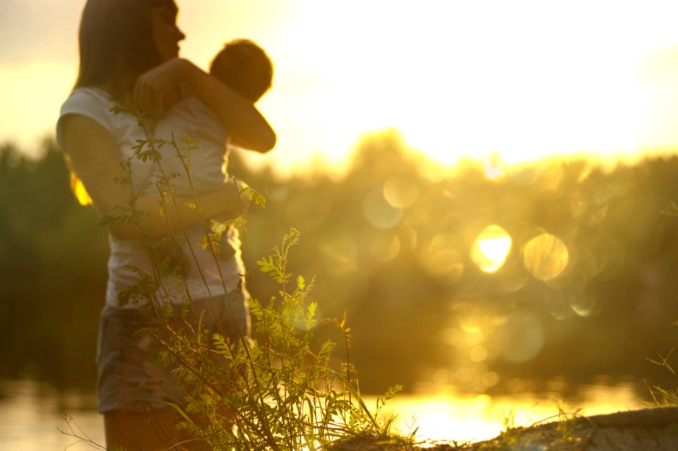 Selective Focus Photography Of Woman Carrying Baby photo