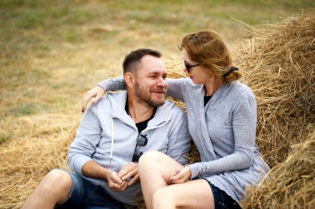 Man And Woman Sitting On Hay photo