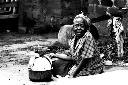 Woman Sitting On Soil Beside Cooking Pot photo