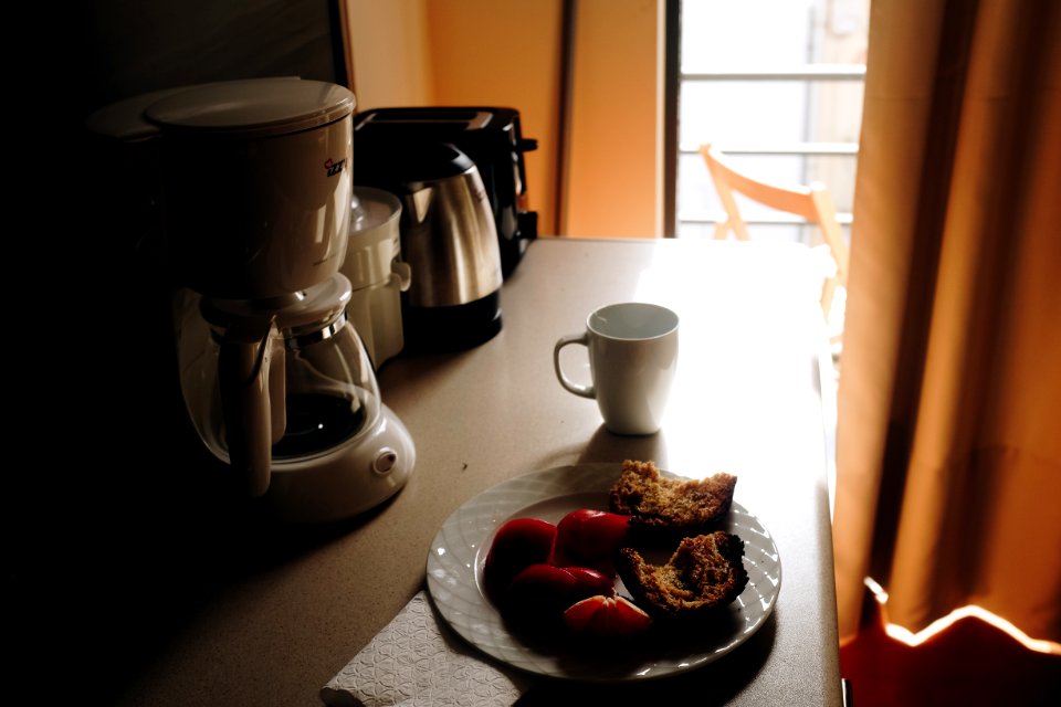 White Ceramic Mug Beside Ceramic Plate On Table photo