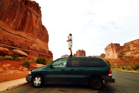 Man Standing On Green Mini Van