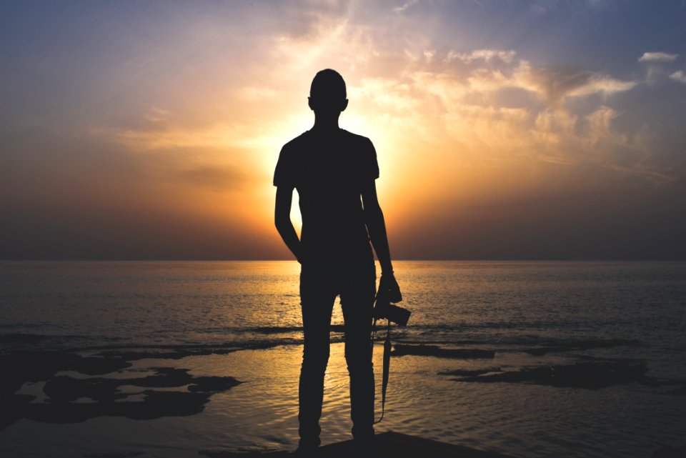Silhouette Photo Of Person Holding Camera