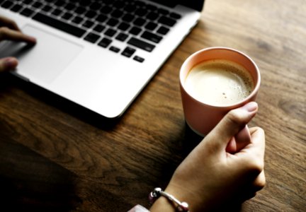 Hand On Cup Of Coffee