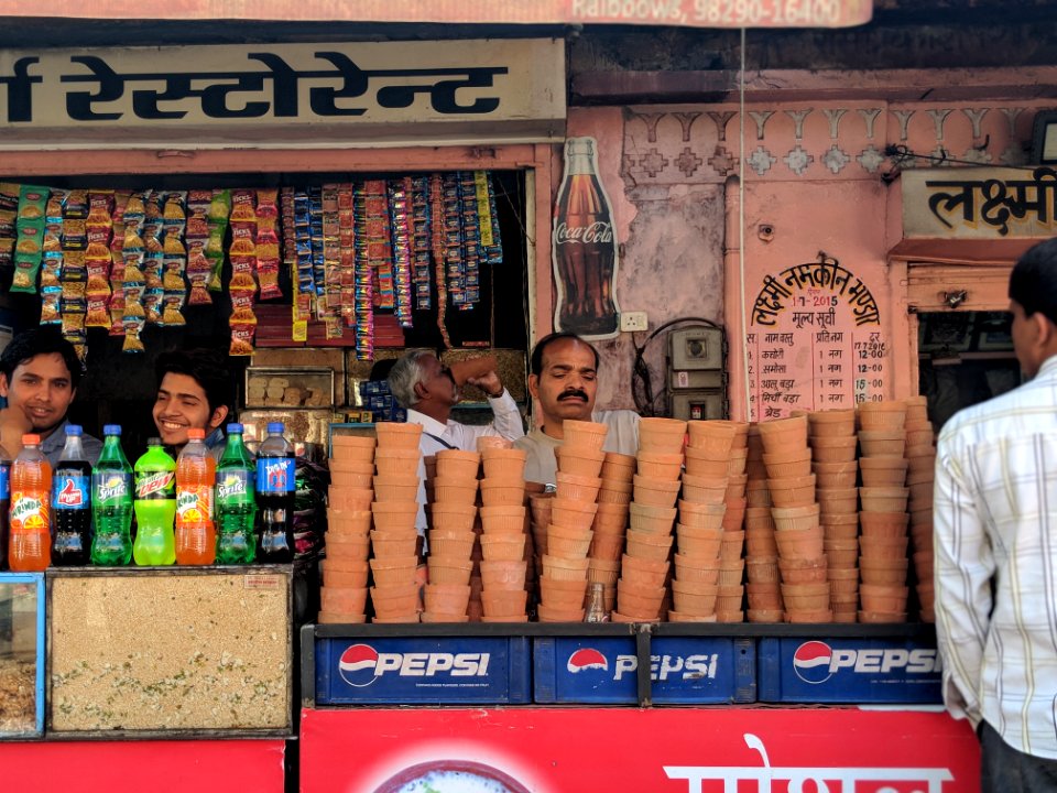 Person Selling Brown Clay Pots