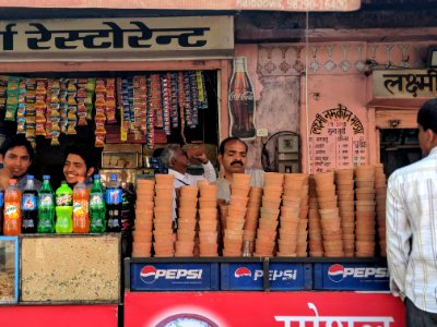 Person Selling Brown Clay Pots