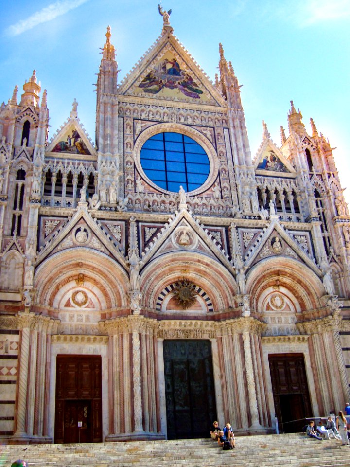 People Sitting On Stairs Of Cathedral