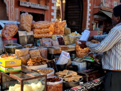 Man In Long-sleeved Shirt Standing Beside Food Stall