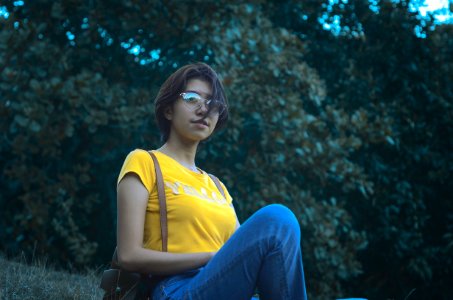 Woman In Yellow Short-sleeved Top And Blue Denim Jeans photo