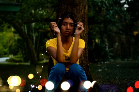 Girl In Yellow Top Sitting Beside Tree
