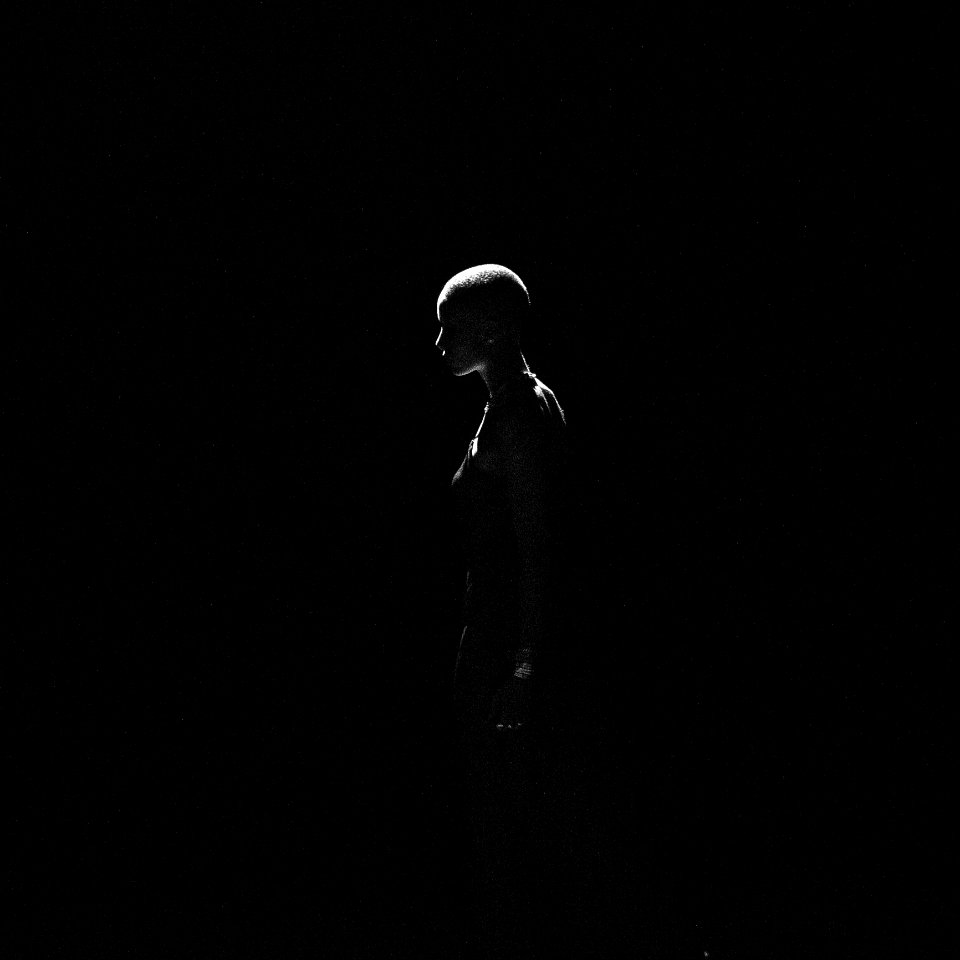 Low Light Photography Of Woman On Dark Room