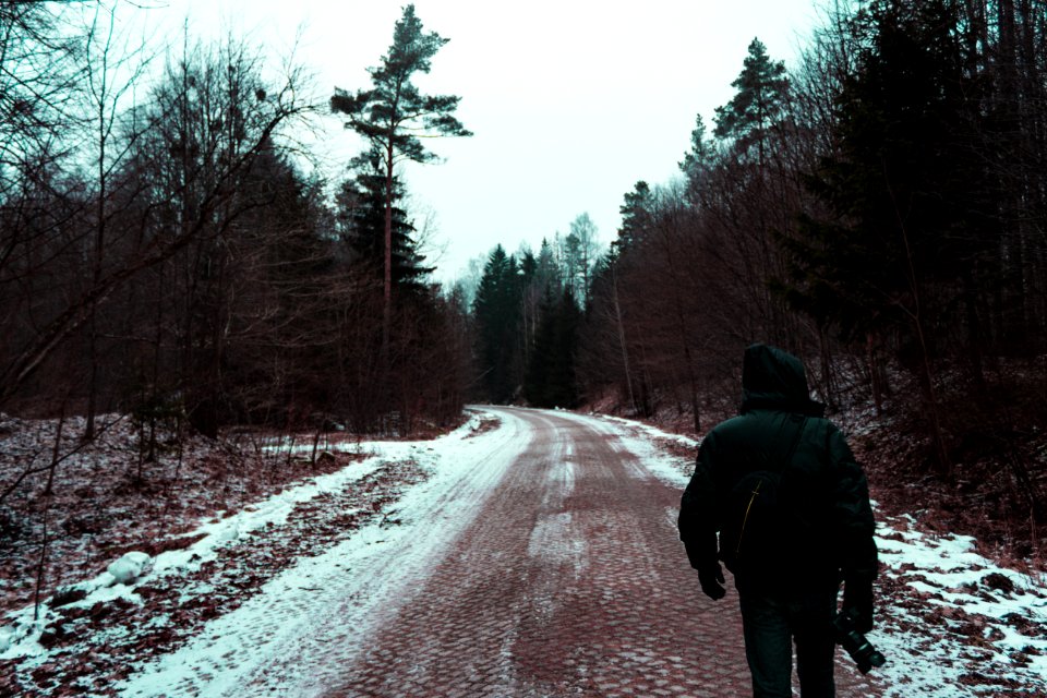 Person In Black Hoodie Top And Black Pants On The Road Holding A Camera