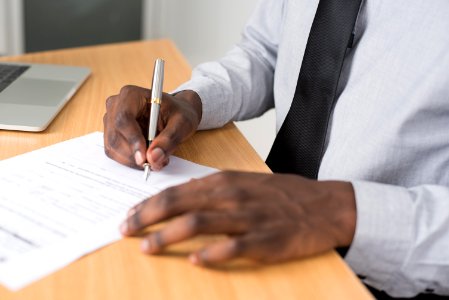 Person Wearing White Dress Shirt Signing Contract photo