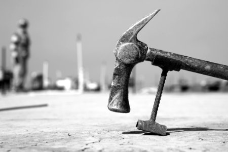 Grayscale Photo Of Hammer On Pavement photo