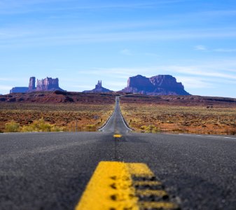 Focus Photo Of Roadway Going Towards Mountains