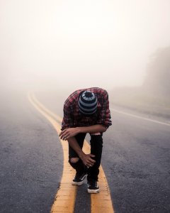 Man Wearing Red Plaid Shirt Standing In Center Road