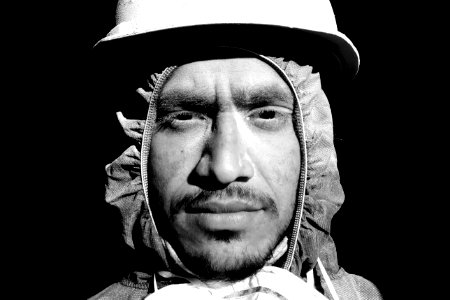 Grayscale Photograph Of Man Wearing Hooded Top And Hard Hat photo