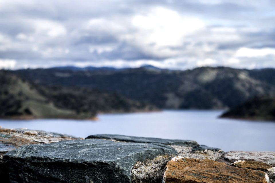 Photography Of Lake Between Mountain At Daytime