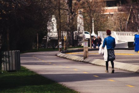 Woman Wearing Blue-washed Denim Jacket Walking On Street photo