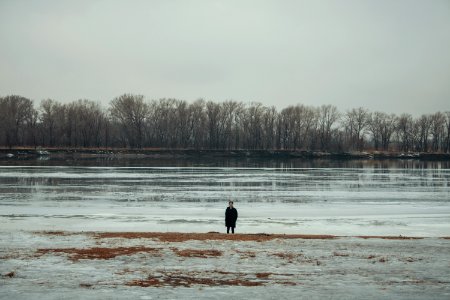 Person Standing Near Body Of Water photo